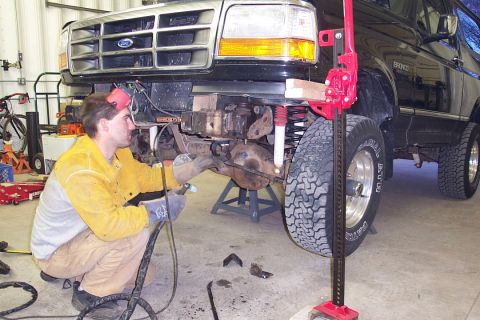 1996 Ford Bronco - Keith getting ready to take off the sway bar mounts.