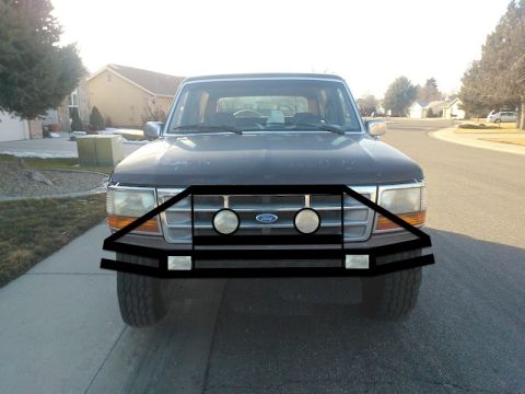 1992 Ford Bronco - Front view of a 1992 Ford Bronco, highlighting its grille and aftermarket bumper with integrated fog lights.