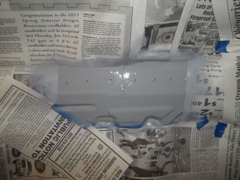 1990 Ford Bronco - Newspaper protects a vehicle part during a painting or repair process.