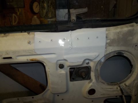1990 Ford Bronco - Close-up of a vehicle's firewall undergoing repair work, with visible patching and metalwork.