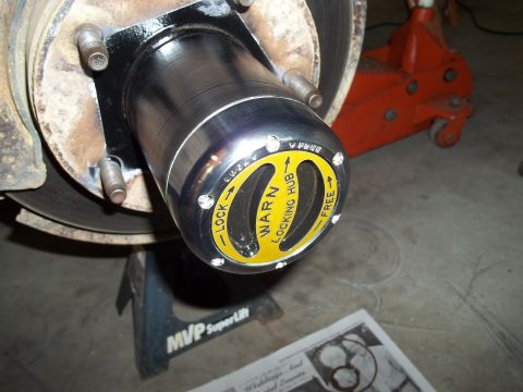 1990 Ford Bronco - Close-up of a Warn locking hub, indicating its function for engaging or disengaging four-wheel drive.