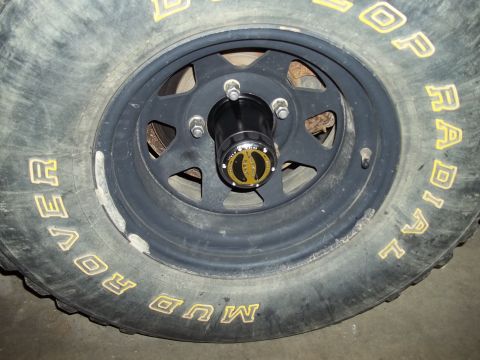 1990 Ford Bronco - Close-up of a wheel and tire assembly, likely from an off-road vehicle.