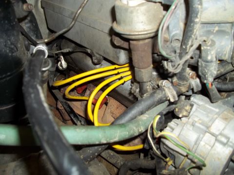 1990 Ford Bronco - Close-up view of engine components, including spark plug wires and distributor cap.