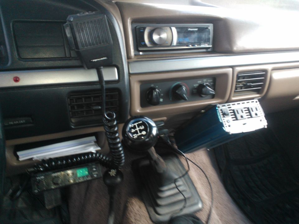 Interior view of a vehicle with a Realistic CB radio, Pioneer stereo, and aftermarket amplifier