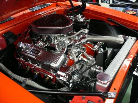 1968 Chevrolet Camaro - The engine bay of a 1968 Chevrolet Camaro features a highly polished chrome engine with an orange exterior.