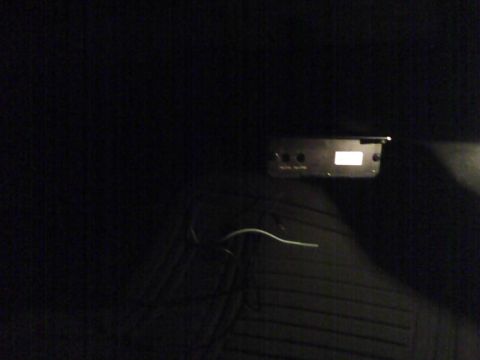 2003 Ford Crown Victoria - An aftermarket car stereo unit is visible in the dark interior of a vehicle.