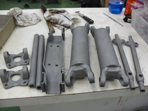 1976 Chevrolet Corvette - Various driveshaft parts, including yokes and tubes, are prepared on a workbench.
