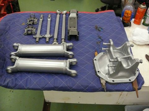 1976 Chevrolet Corvette - Various automotive drivetrain components are neatly arranged on a protective blue cloth for inspection or assembly.