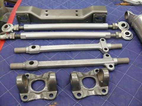 1976 Chevrolet Corvette - Various automotive suspension and drivetrain parts are displayed on a blue mat.