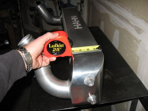 1995 Ford Bronco - A person is measuring a large metal intercooler with a tape measure. The intercooler has the brand name 'HAHN' visible.