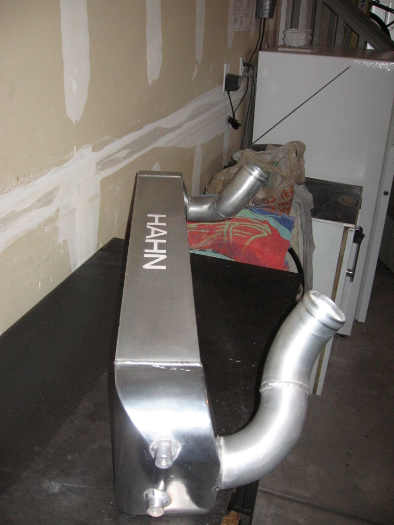 Aluminum intercooler with 'HAHN' logo and two pipes