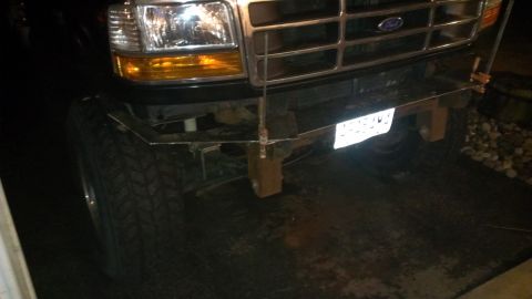 1995 Ford Bronco - The front of a 1992 Ford F-Series truck is visible, a custom bumper and off-road tires.
