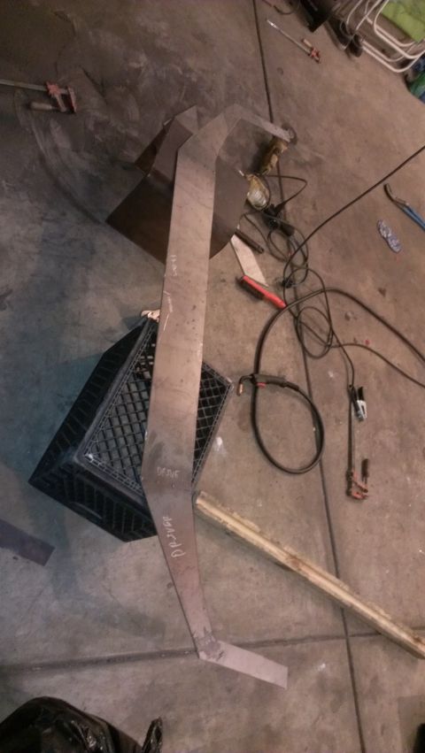 1995 Ford Bronco - Fabricated metal part with handwritten markings sits on a workshop floor.
