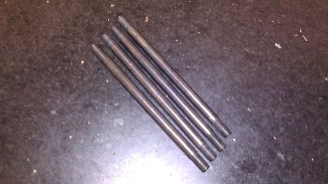1996 Ford Bronco - A set of five metal rods, each with threaded ends, are laid out on a dark, speckled surface.
