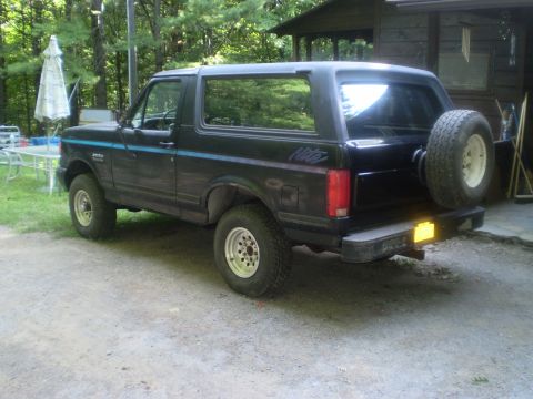1979 Ford Bronco - This black Ford Bronco has a "Nite" decal on the rear quarter panel and a spare tire mounted externally.