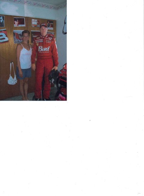 1981 Ford Bronco - A man in a red racing suit and a woman pose for a photo in a room decorated with racing memorabilia.