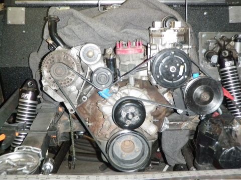 1961 International Scout 800 - Close-up view of an engine assembly with various accessories and belts.