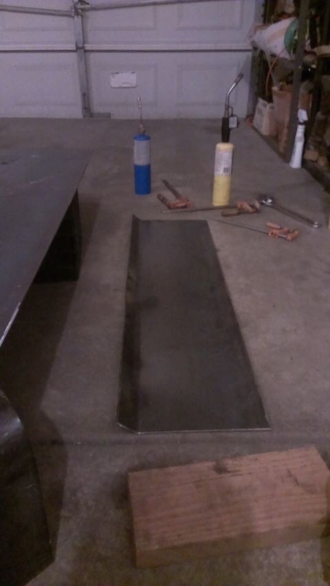 1995 Ford Bronco - Sheet metal and tools laid out on a garage floor, ready for work.