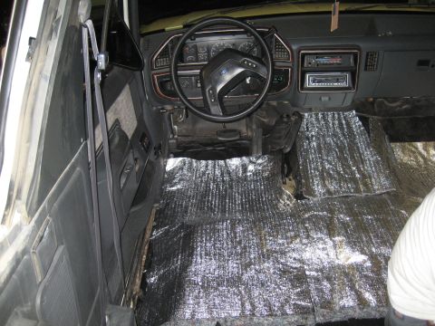 1989 Ford Bronco - Interior of a 1989 Ford Bronco with sound deadening material installed on the floor.
