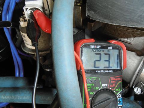 1990 Ford Bronco - Testing resistance with a multimeter on an engine part.
