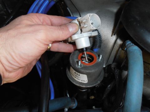 1990 Ford Bronco - Removing the EVP sensor from its mounting bracket on an engine component.