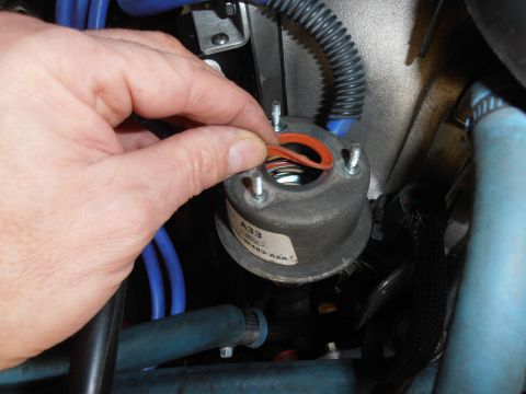 1990 Ford Bronco - A hand is shown installing an orange gasket onto a Ford EVP sensor during a repair.