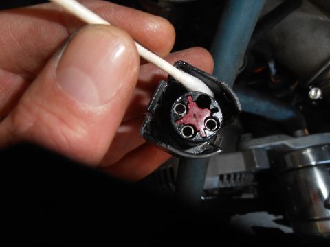1990 Ford Bronco - Cleaning an electrical connector with a cotton swab.