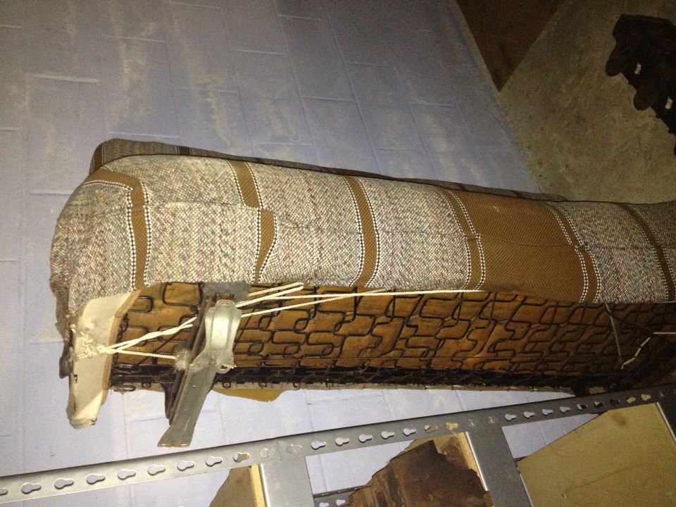 Bench seat upholstery with brown and tan woven fabric and a brown patterned underlay