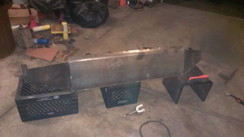 1995 Ford Bronco - A custom metal bumper is being fabricated and supported by milk crates in a workshop.