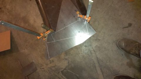 1995 Ford Bronco - Metal sheet being fabricated and clamped in place, with cut lines visible on the surface.