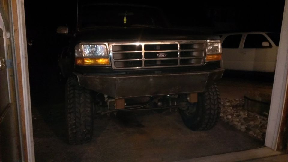 Front view of black 1995 Ford Bronco with custom bumper and large tires