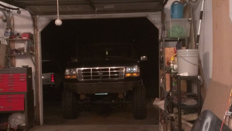 1995 Ford Bronco front view in a garage with a custom bumper