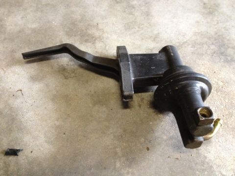 1978 Ford Bronco - Mechanical fuel pump with lever arm and brass fitting shown on concrete floor.