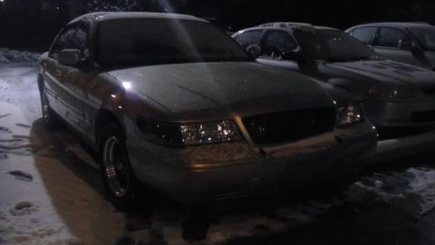 2000 Mercury Grand Marquis - A silver 2000 Mercury Grand Marquis is parked outside in the snow.