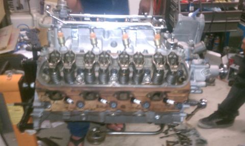 1989 Ford Bronco - Engine assembly with visible spark plugs and valve train components.