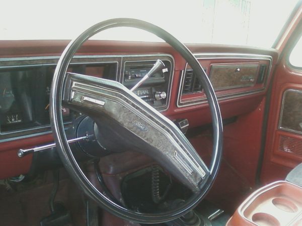 1978 Ford Bronco interior with woodgrain trim and Ford steering wheel