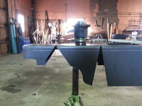1994 Ford Bronco - Fabricated bumper sections are mounted on a stand in a workshop environment.
