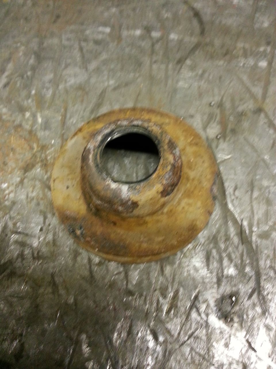 Rusty metal part with a circular opening