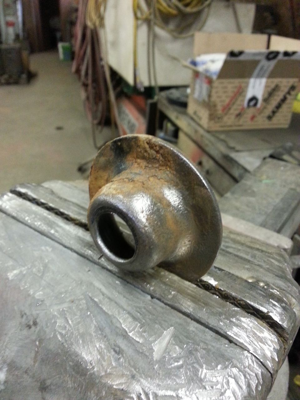 rusted metal part clamped in a vise