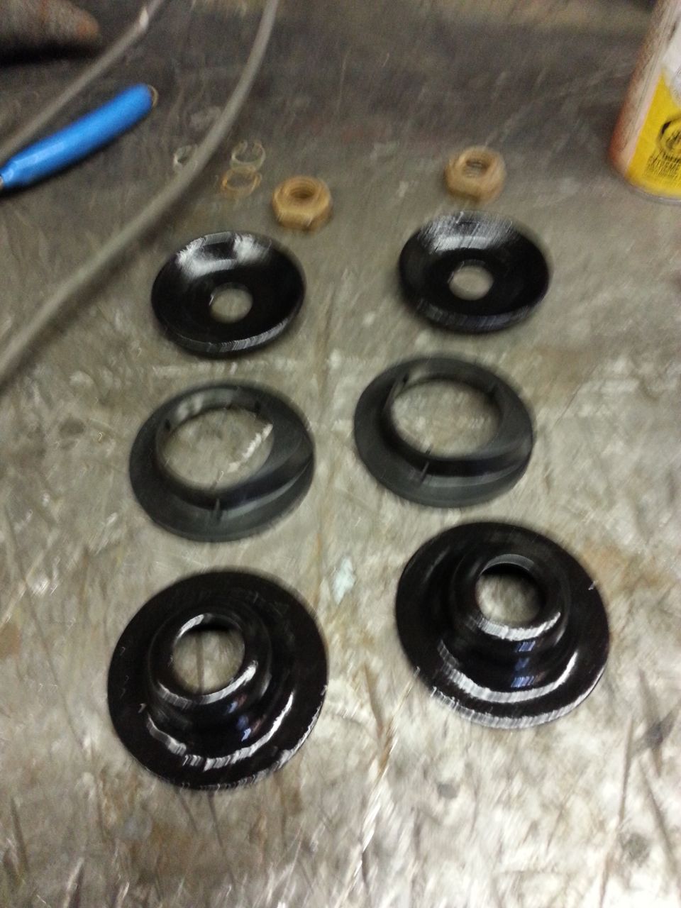 Spring isolators and nuts on a workbench