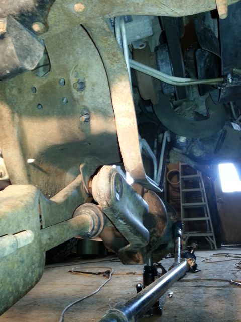 1994 Ford Bronco - Close-up view of heavily rusted vehicle suspension components, suggesting a need for repair or maintenance.