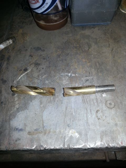1994 Ford Bronco - A drill bit has snapped into two pieces, lying on a metal surface.