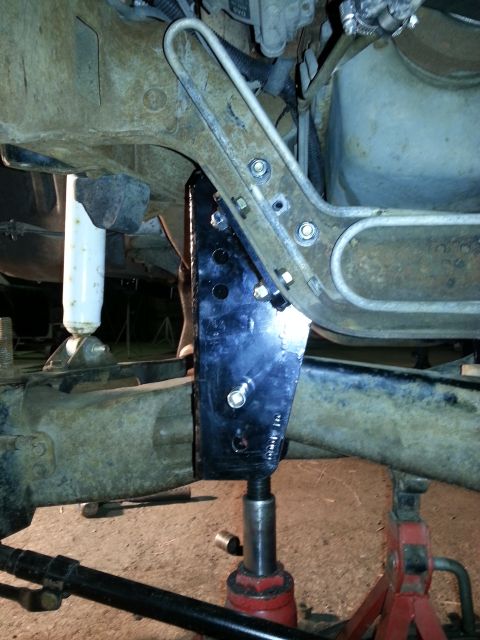 1994 Ford Bronco - Close-up view of vehicle frame and suspension modifications, showing a newly installed bracket.