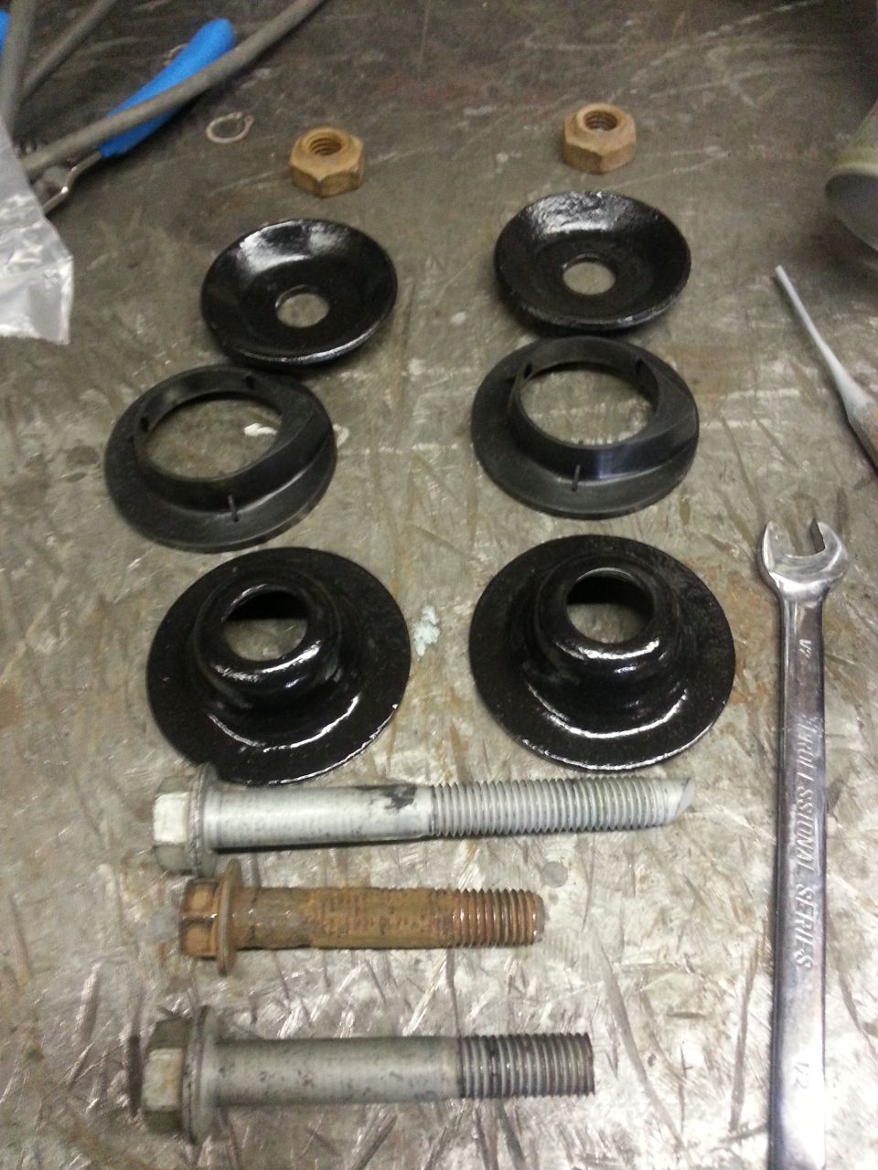 Suspension parts and bolts on a workbench