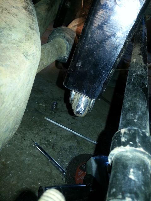 1994 Ford Bronco - Undercarriage view of vehicle suspension components, with tools suggesting repair work.