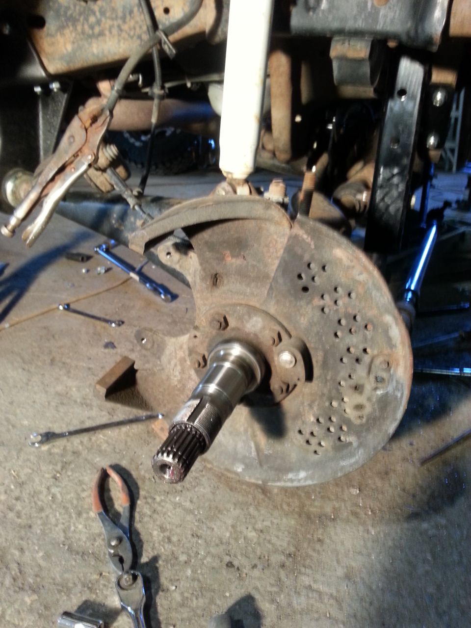 Vehicle's front wheel hub and brake rotor assembly, with tools scattered around