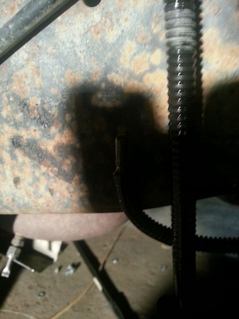 1994 Ford Bronco - A close-up view of a rusted vehicle frame and a ribbed belt, with a SuperMotors.net watermark visible.