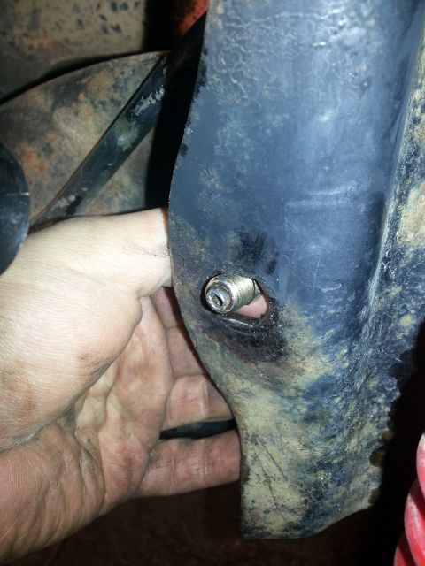 1994 Ford Bronco - A hand is shown on a greasy metal component, possibly during maintenance or repair.