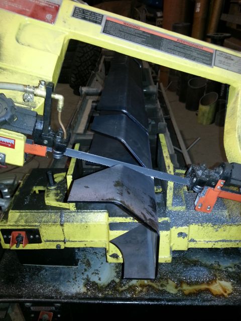 1994 Ford Bronco - Metal fabrication in progress, with parts being cut on a band saw.