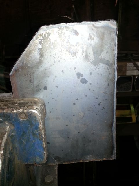 1994 Ford Bronco - A metal panel is secured in a vise, showing signs of wear and staining.